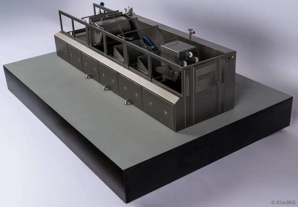 Cooking line model from the discharge end, showing the vented end cabinet with control lights beside open tanks